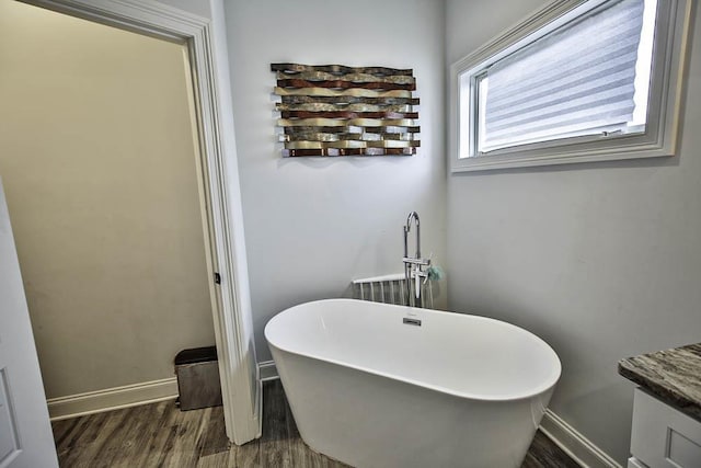 bathroom featuring vanity, a bathing tub, and hardwood / wood-style floors