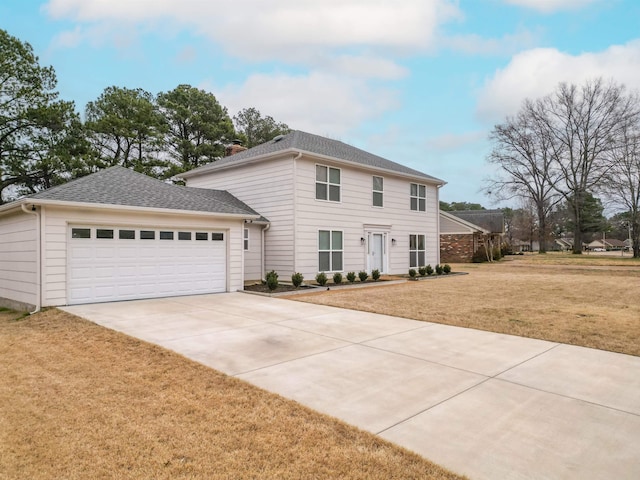 view of front facade featuring a front yard and a garage