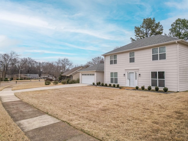 view of front of house featuring a garage and a front lawn