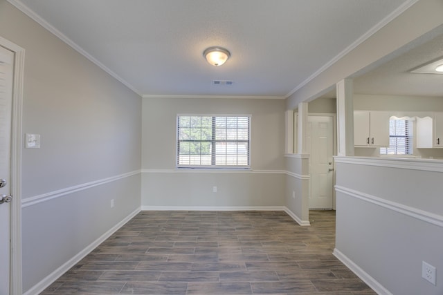 unfurnished room featuring a textured ceiling, ornamental molding, and wood-type flooring