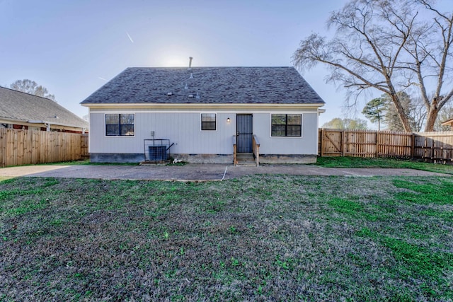 back of property featuring a patio, a lawn, and central air condition unit