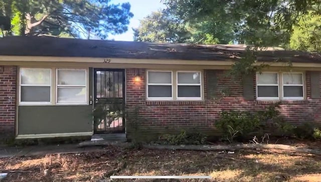 view of front of house featuring brick siding