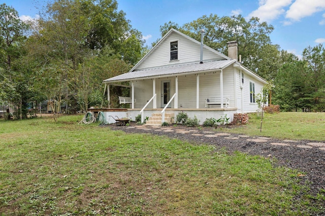 farmhouse featuring a front lawn and a porch