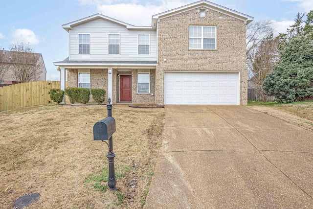 traditional-style house featuring brick siding, a front yard, driveway, an attached garage, and fence