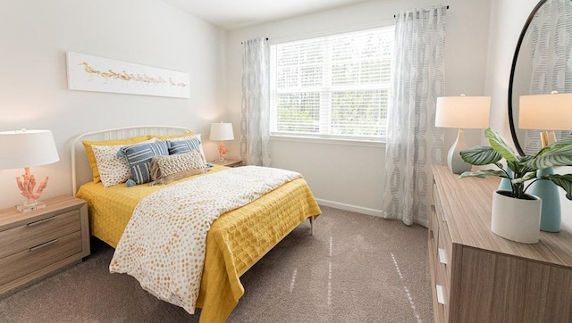 carpeted bedroom featuring baseboards