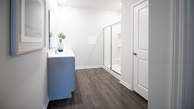 hallway with dark wood-style floors and baseboards