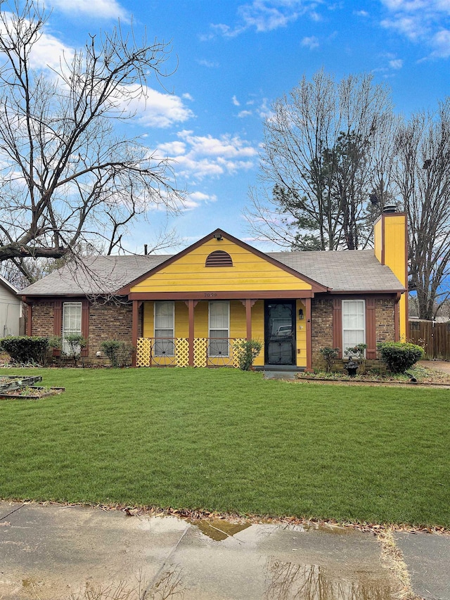 single story home with a front yard, brick siding, and a chimney