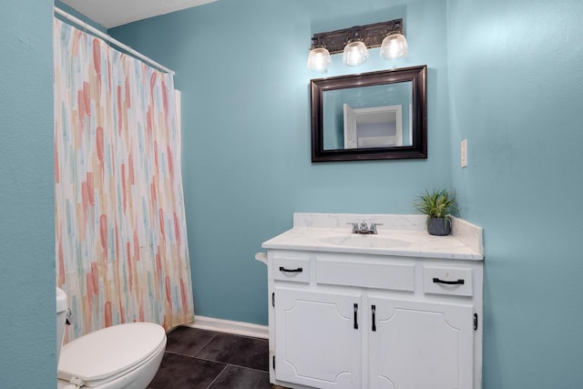 full bathroom featuring toilet, vanity, baseboards, and tile patterned floors