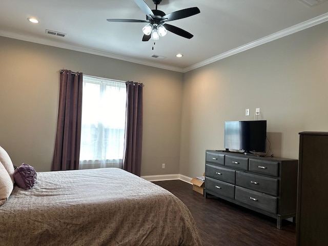 bedroom featuring dark wood-style floors, ornamental molding, visible vents, and baseboards