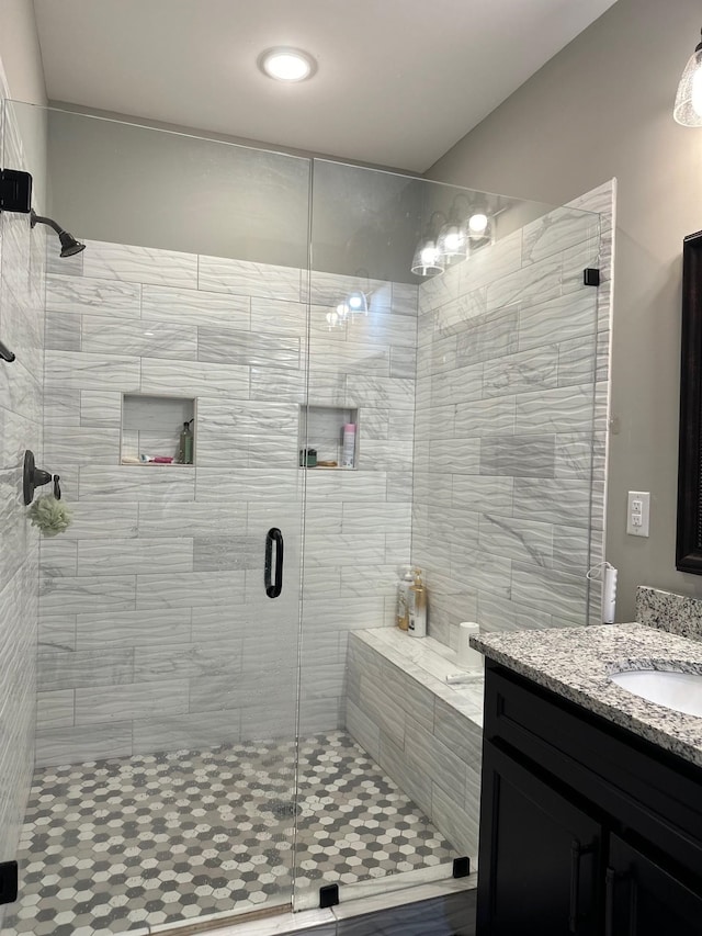 full bathroom featuring a stall shower and vanity