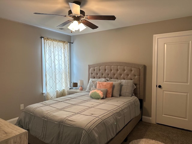 carpeted bedroom featuring ceiling fan, visible vents, and baseboards