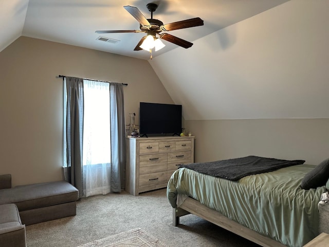 bedroom featuring lofted ceiling, visible vents, light carpet, and multiple windows