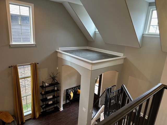 staircase with lofted ceiling and wood finished floors