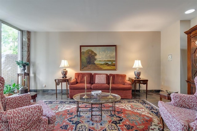 living area featuring floor to ceiling windows and baseboards