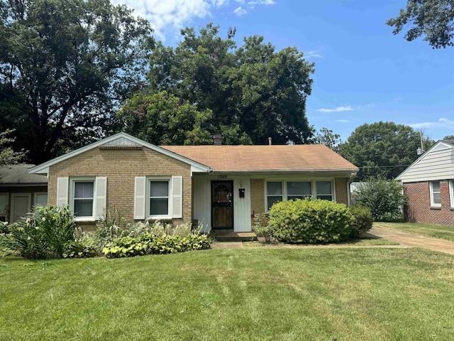 single story home with a front lawn and brick siding