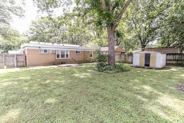 view of yard featuring a fenced backyard, an outdoor structure, and a shed