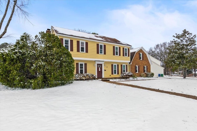 colonial inspired home featuring a chimney