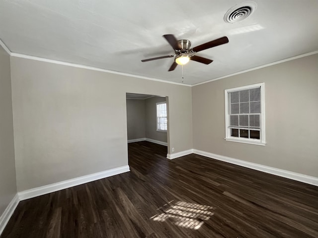 unfurnished room with ceiling fan, dark wood-style flooring, visible vents, baseboards, and ornamental molding