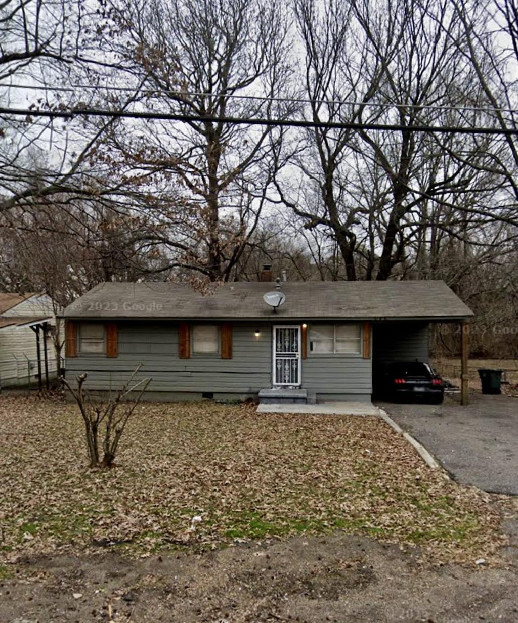 ranch-style house with driveway, an attached carport, and crawl space