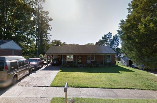 view of front of house with a carport, driveway, and a front lawn