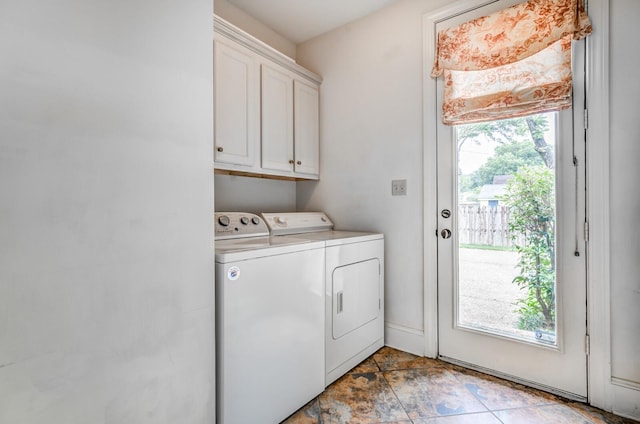 washroom with cabinet space and washing machine and dryer