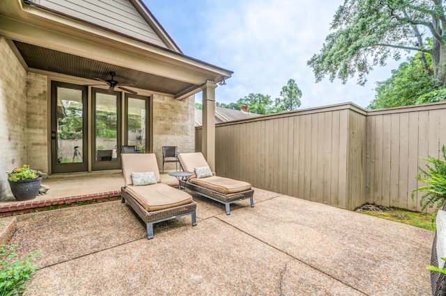 view of patio / terrace with ceiling fan and fence