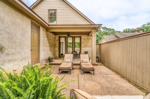 view of patio featuring fence and a ceiling fan