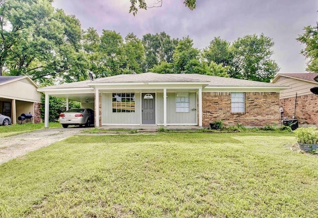 ranch-style house with a carport, a front yard, brick siding, and driveway