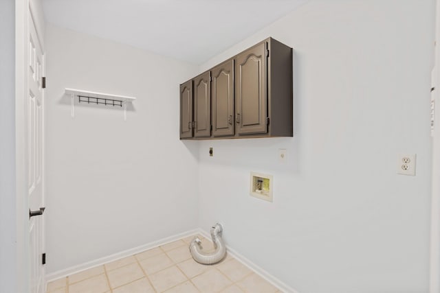 clothes washing area with washer hookup, cabinet space, hookup for an electric dryer, gas dryer hookup, and baseboards