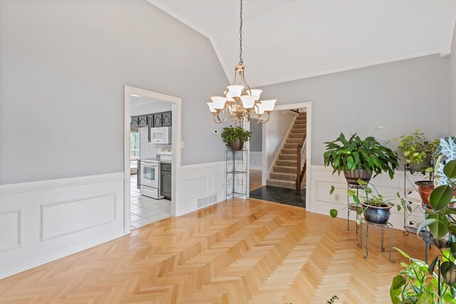 unfurnished dining area with a chandelier, visible vents, stairs, vaulted ceiling, and wainscoting