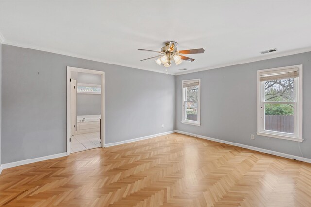 spare room with a healthy amount of sunlight, visible vents, and baseboards