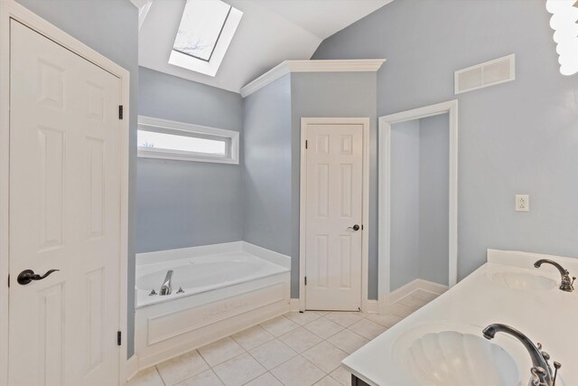 full bath featuring tile patterned flooring, visible vents, a sink, and vaulted ceiling with skylight