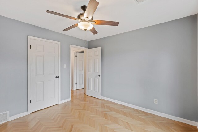 unfurnished room with visible vents, ceiling fan, and baseboards