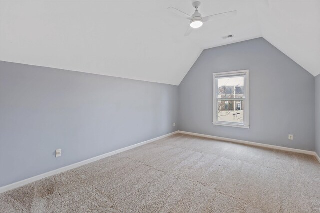 bonus room featuring carpet floors, lofted ceiling, visible vents, a ceiling fan, and baseboards