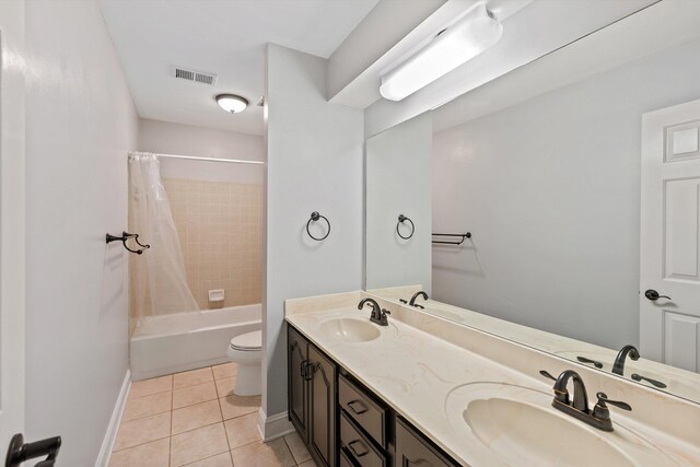 bathroom with visible vents, shower / bath combo with shower curtain, a sink, and tile patterned floors