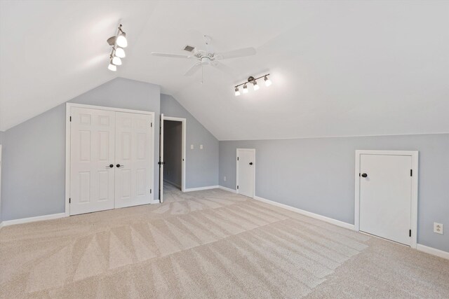 bonus room with light carpet, ceiling fan, baseboards, and vaulted ceiling