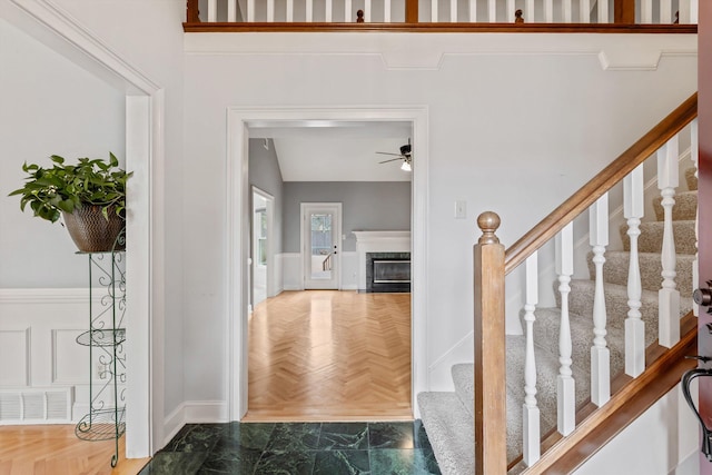 entrance foyer featuring ceiling fan, a fireplace, and visible vents