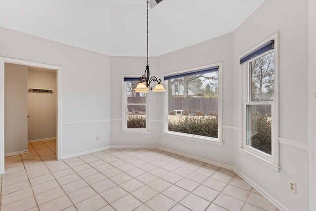 unfurnished dining area with baseboards, light tile patterned floors, and a notable chandelier