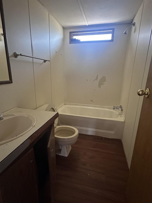 full bath featuring toilet, shower / bathing tub combination, wood finished floors, and vanity