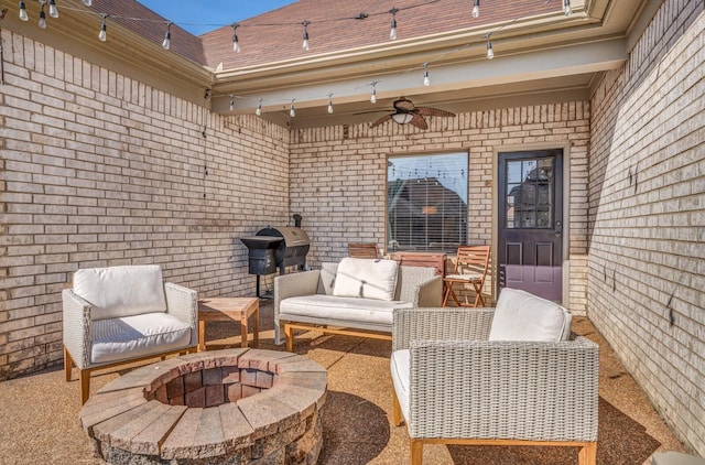 view of patio / terrace featuring a ceiling fan, an outdoor living space with a fire pit, and area for grilling