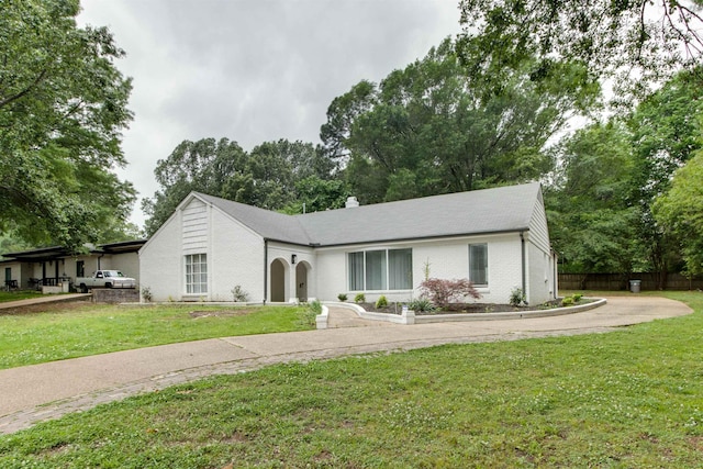 ranch-style home with brick siding and a front lawn