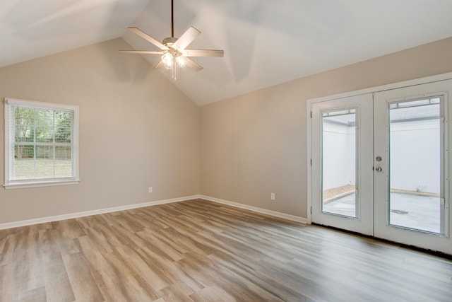 unfurnished room featuring baseboards, a ceiling fan, lofted ceiling, french doors, and light wood-type flooring