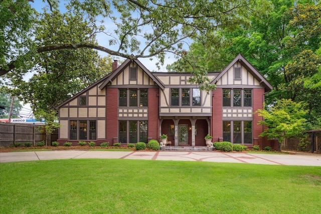 view of front of property featuring a chimney, a front yard, and fence