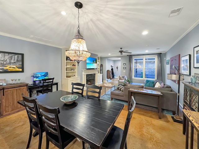 dining room with a fireplace, visible vents, crown molding, and recessed lighting