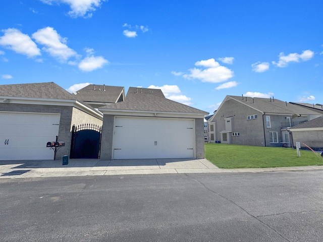 view of front of property with a garage, a residential view, brick siding, and a front yard