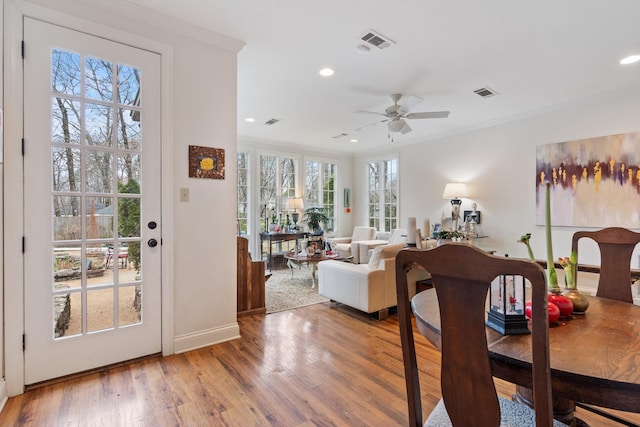 dining room with recessed lighting, visible vents, crown molding, and wood finished floors