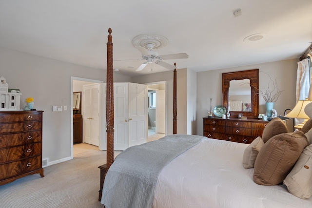 bedroom with light carpet, ceiling fan, visible vents, and baseboards