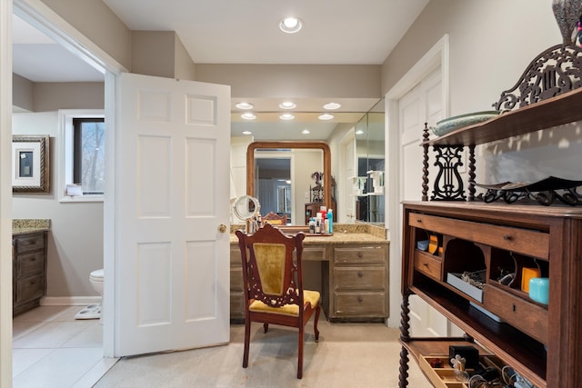 interior space featuring ensuite bathroom, light tile patterned flooring, baseboards, and recessed lighting