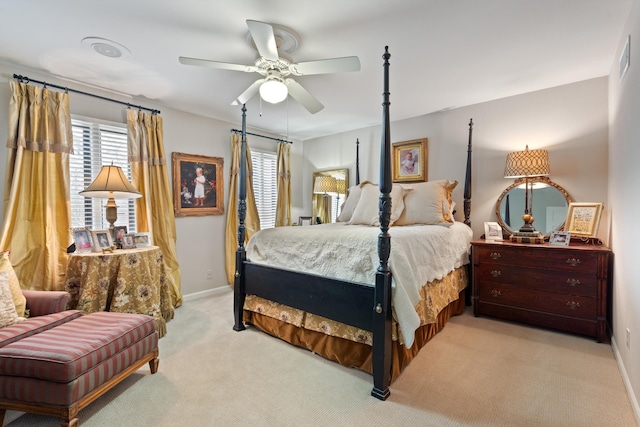 bedroom featuring a ceiling fan, light carpet, and baseboards