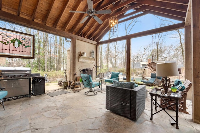 sunroom / solarium featuring lofted ceiling with beams, a healthy amount of sunlight, wood ceiling, and a ceiling fan